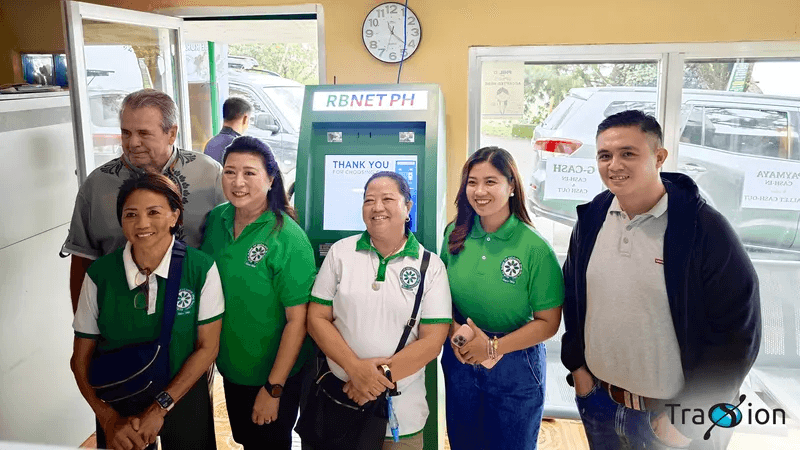 Rural Bank of Escalante staff in green shirts and guests gathered around the branch's new RBNET PH Cash Teller Machine.
